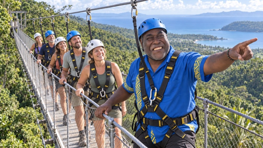 Frazer leading a group across the Sky Bridge zipline crossing